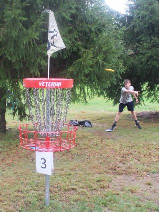 Enterprise’s Gavin Bridgewater, playing in a threesome with Kingstonians Emilio Ciccarelli and Aaron Dodson, putts out on the third hole during the disc golf tournament Saturday at Hunter’s Creek Golf Course. Photo/Craig Bakay